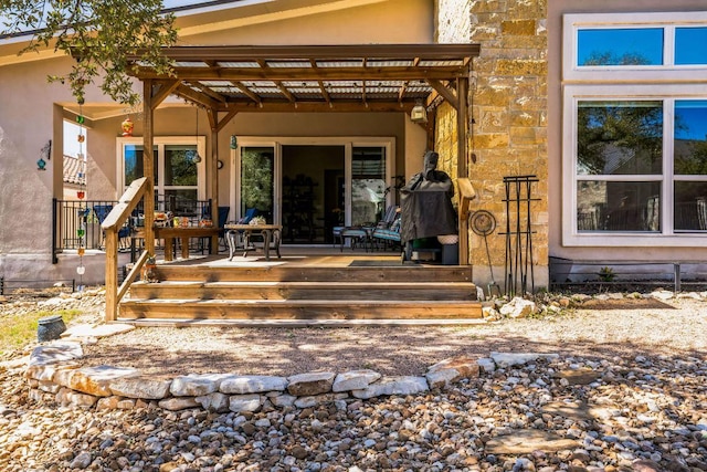 property entrance with stone siding and stucco siding