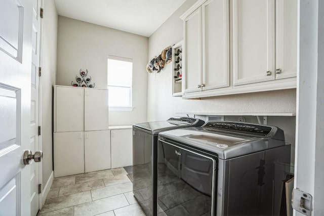 clothes washing area with cabinet space and washing machine and clothes dryer