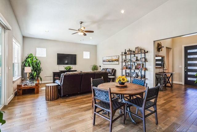 dining space featuring baseboards, ceiling fan, light wood-type flooring, lofted ceiling, and recessed lighting