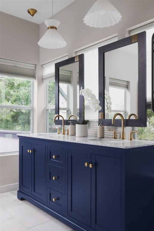 bathroom with a sink, double vanity, and tile patterned floors