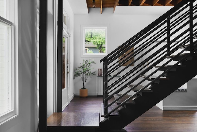 stairs with wood finished floors and baseboards