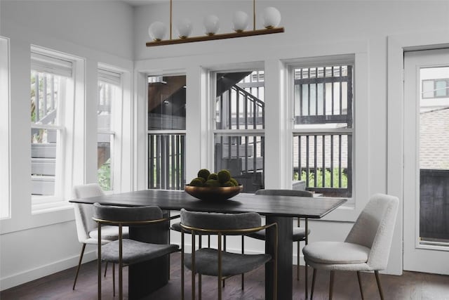 dining area featuring dark wood finished floors and baseboards