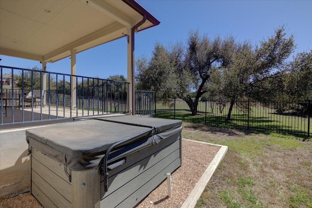 view of yard with fence and a hot tub