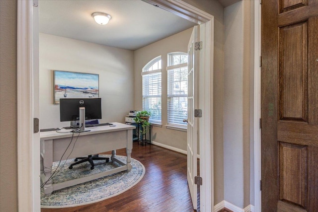 office space with dark wood-style floors and baseboards