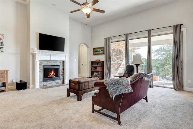 114 Angela Rose Ct, Austin, TX 78737 - living room featuring carpet flooring, ceiling fan, a towering ceiling, a fireplace, and baseboards
