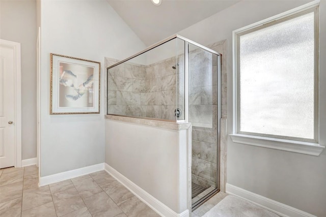 114 Angela Rose Ct, Austin, TX 78737 - bathroom featuring tiled shower, vaulted ceiling, baseboards, and marble finish flooring
