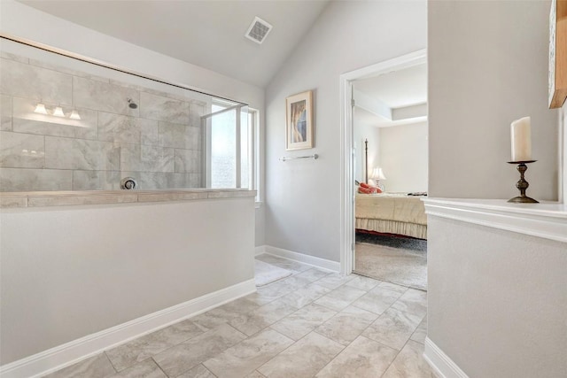 114 Angela Rose Ct, Austin, TX 78737 - ensuite bathroom with a walk in shower, marble look tile flooring, lofted ceiling, and baseboards