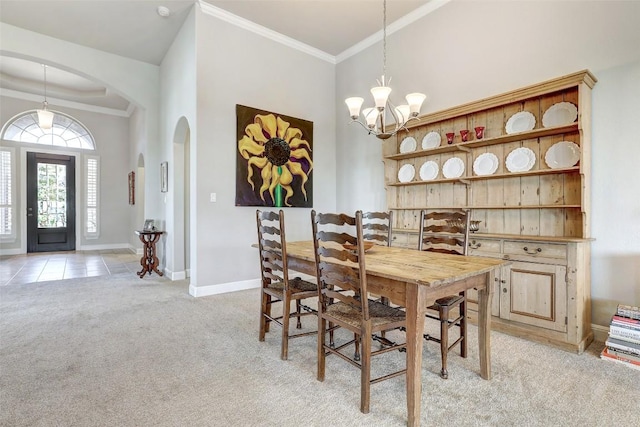 114 Angela Rose Ct, Austin, TX 78737 - dining area featuring arched walkways, light carpet, baseboards, a chandelier, and ornamental molding