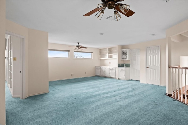 unfurnished living room with visible vents, light carpet, baseboards, and ceiling fan