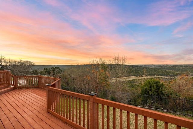 wooden terrace with a wooded view