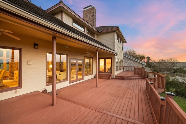 wooden terrace featuring french doors and ceiling fan