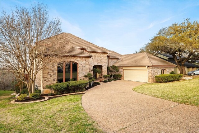 5315 Valburn Cir, Austin, TX 78731 - french provincial home featuring concrete driveway, a garage, a front yard, and a tile roof