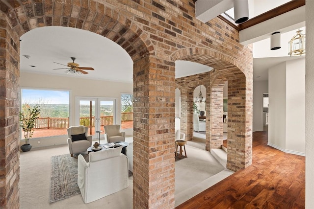 interior space with french doors and ceiling fan