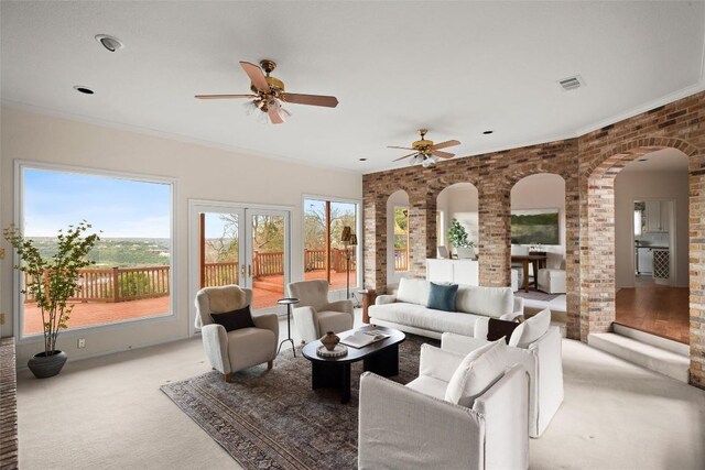5315 Valburn Cir, Austin, TX 78731 - carpeted living room with arched walkways, a ceiling fan, and ornate columns