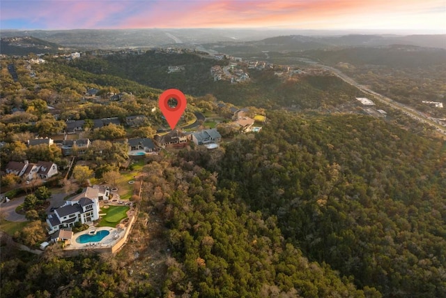 birds eye view of property with a wooded view