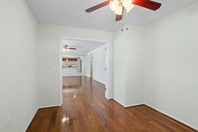 hallway with wood finished floors and baseboards