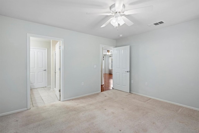 unfurnished bedroom with visible vents, baseboards, connected bathroom, and carpet flooring