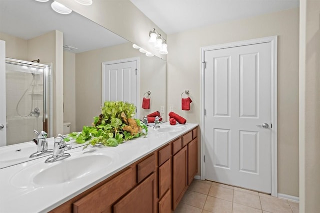 full bathroom featuring tile patterned flooring, a stall shower, and a sink