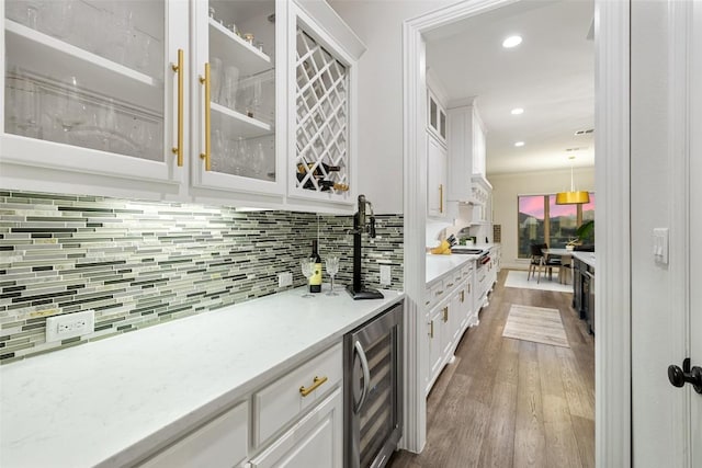 bar with tasteful backsplash, dark wood-type flooring, wine cooler, recessed lighting, and bar