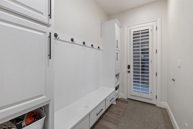 mudroom featuring dark wood-style floors and baseboards