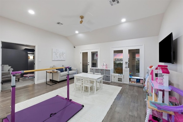 playroom featuring french doors, visible vents, wood finished floors, and vaulted ceiling