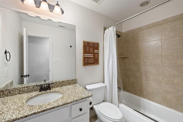 full bath with visible vents, vanity, toilet, and shower / tub combo