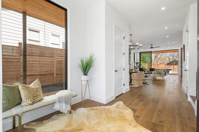 corridor with recessed lighting, baseboards, and hardwood / wood-style flooring