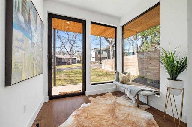 sitting room featuring baseboards and wood finished floors