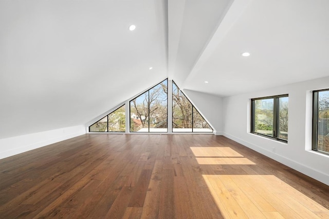 unfurnished living room featuring lofted ceiling, recessed lighting, baseboards, and wood-type flooring