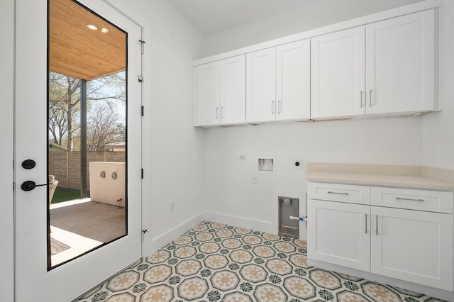 washroom with baseboards, gas dryer hookup, washer hookup, cabinet space, and hookup for an electric dryer