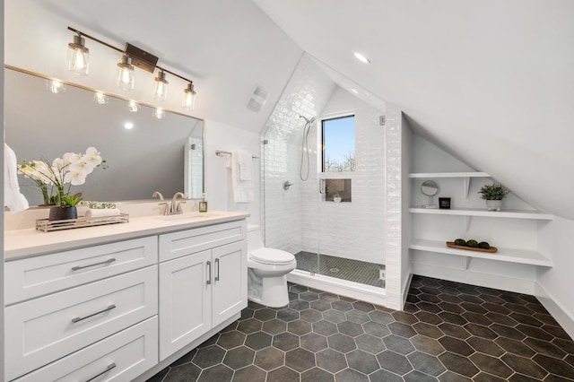 full bathroom featuring vanity, lofted ceiling, tile patterned flooring, a shower stall, and toilet