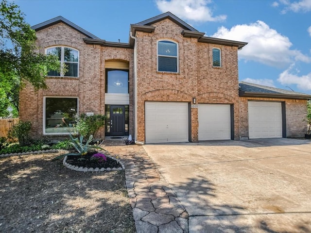 view of front of house featuring brick siding, driveway, a garage, and fence