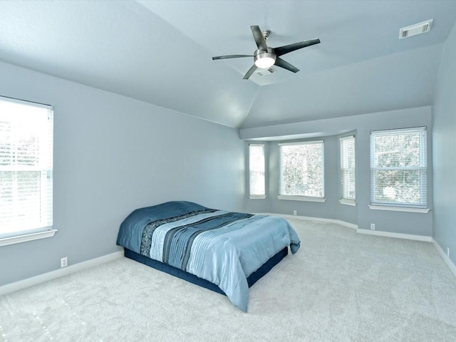 carpeted bedroom featuring visible vents, baseboards, lofted ceiling, and ceiling fan