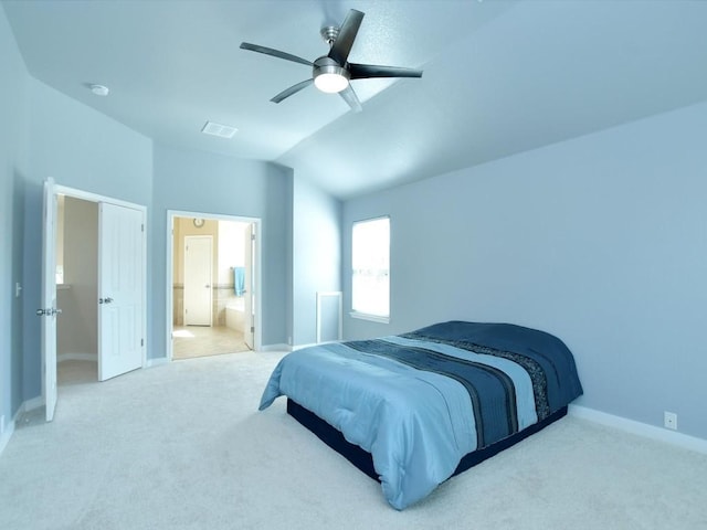 carpeted bedroom featuring visible vents, a ceiling fan, connected bathroom, baseboards, and vaulted ceiling