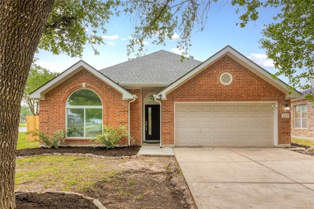 ranch-style house featuring brick siding, an attached garage, driveway, and a shingled roof