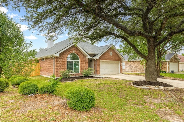 ranch-style home featuring fence, a shingled roof, concrete driveway, a garage, and brick siding