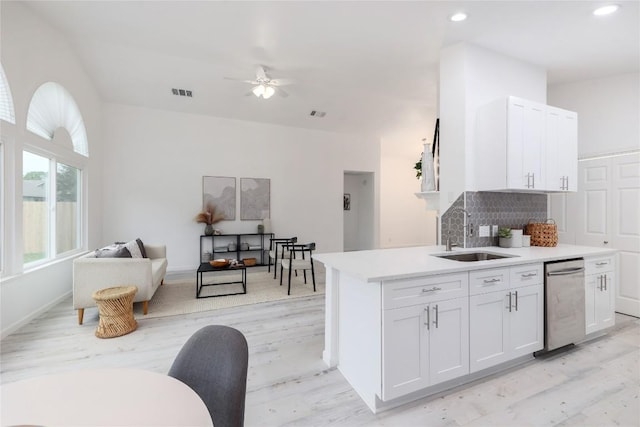 kitchen featuring visible vents, ceiling fan, stainless steel dishwasher, white cabinetry, and a sink