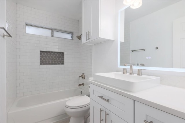 bathroom featuring vanity, toilet, and bathing tub / shower combination