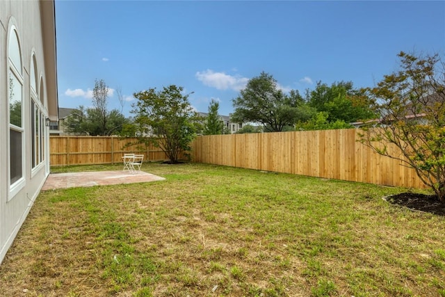 view of yard featuring a patio and a fenced backyard