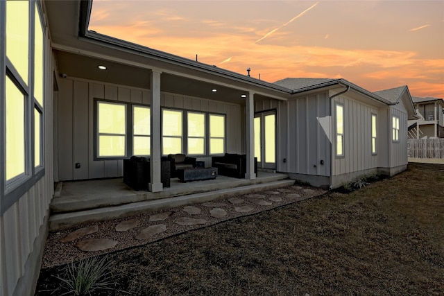 back of property featuring a patio area and board and batten siding