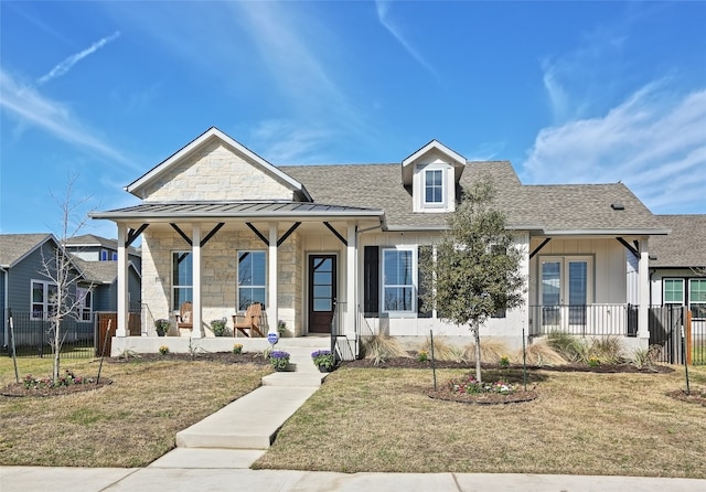 view of front of house with a porch, a front yard, roof with shingles, and fence