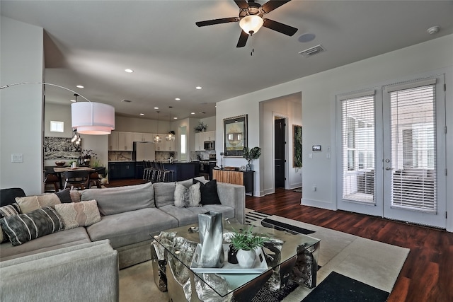 living room featuring visible vents, dark wood-style flooring, and french doors