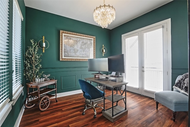 office space featuring a decorative wall, wainscoting, dark wood-style flooring, and a chandelier