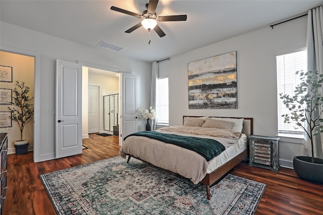 bedroom featuring visible vents, a ceiling fan, baseboards, and wood finished floors