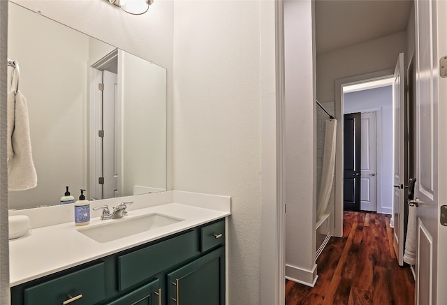 full bathroom with walk in shower, wood finished floors, and vanity