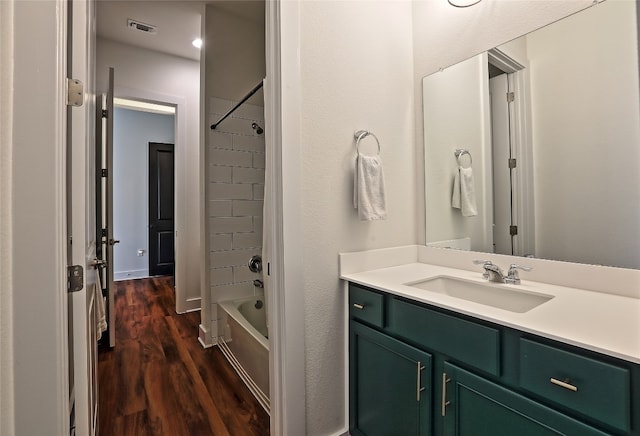 bathroom featuring visible vents, shower / washtub combination, vanity, and wood finished floors