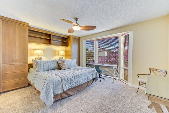 bedroom featuring a textured ceiling, ceiling fan, baseboards, and light carpet