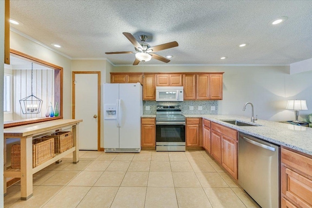 kitchen with light stone counters, a sink, appliances with stainless steel finishes, crown molding, and backsplash