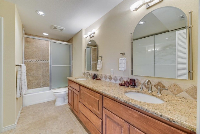 full bath featuring tile patterned flooring, double vanity, toilet, and a sink