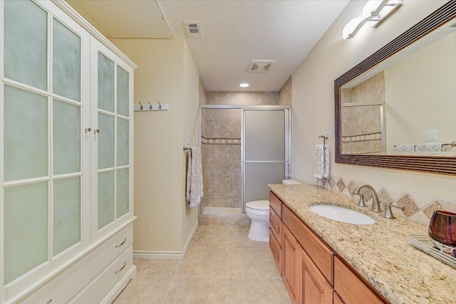 bathroom featuring tile patterned floors, visible vents, toilet, and a stall shower